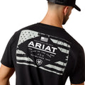Person wearing a black Ariat t-shirt with a graphic design on the back.
