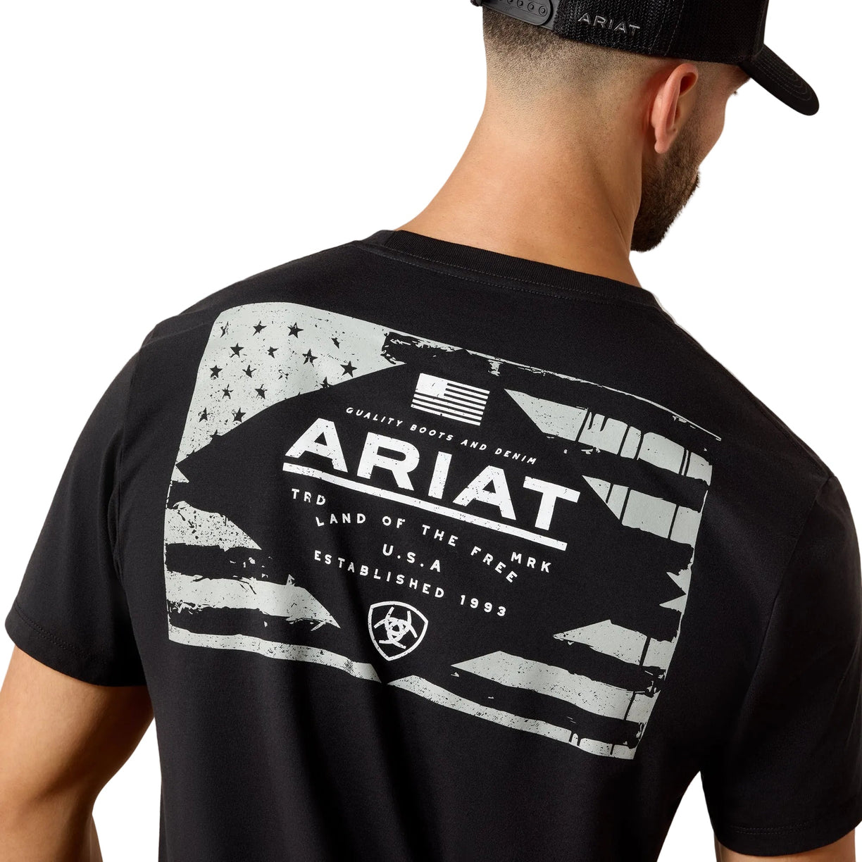 Person wearing a black Ariat t-shirt with a graphic design on the back.