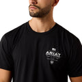 Person wearing a black t-shirt with Ariat logo