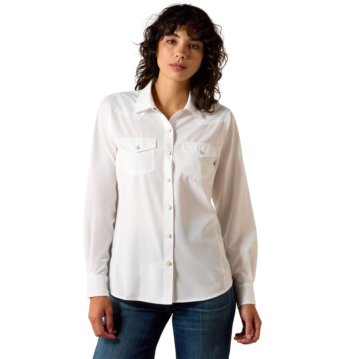 Woman wearing a white button-up shirt and blue jeans on a white background
