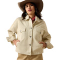 Woman wearing a beige jacket and hat on a white background