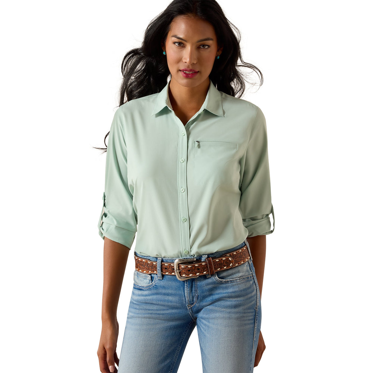 Woman wearing a light green shirt and blue jeans on a white background