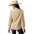 A woman shown from the back wearing a light beige long-sleeve western-style shirt, a matching straw cowboy hat, and dark blue jeans against a plain white background.