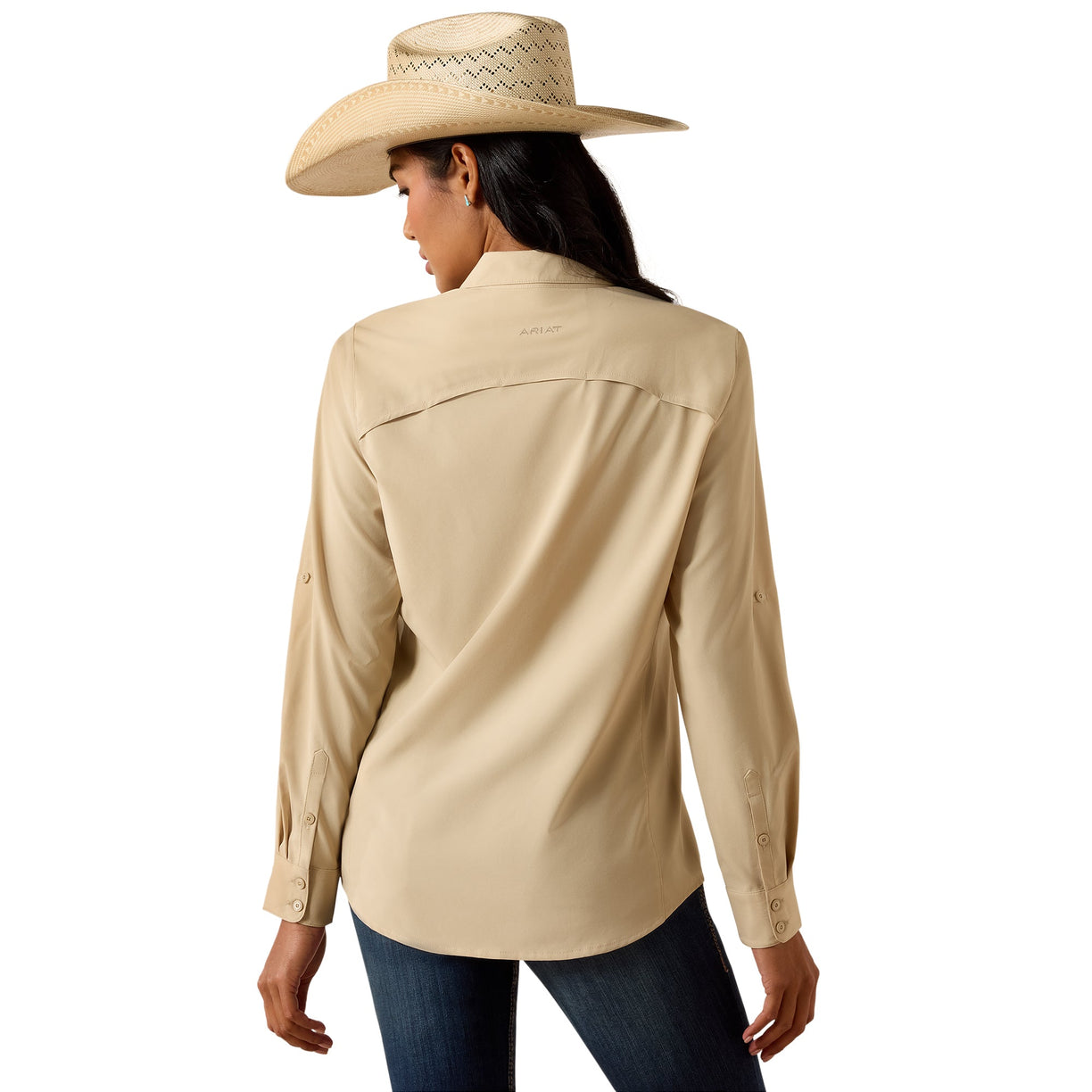 A woman shown from the back wearing a light beige long-sleeve western-style shirt, a matching straw cowboy hat, and dark blue jeans against a plain white background.