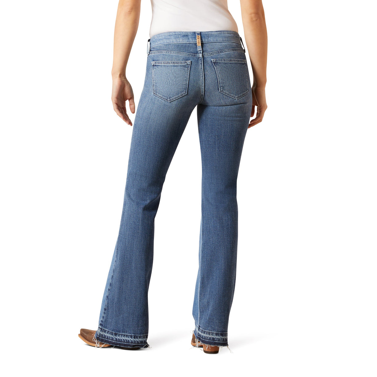 Blue jeans worn by a person on a white background