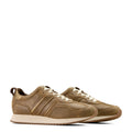 Pair of brown leather sneakers on a light beige background