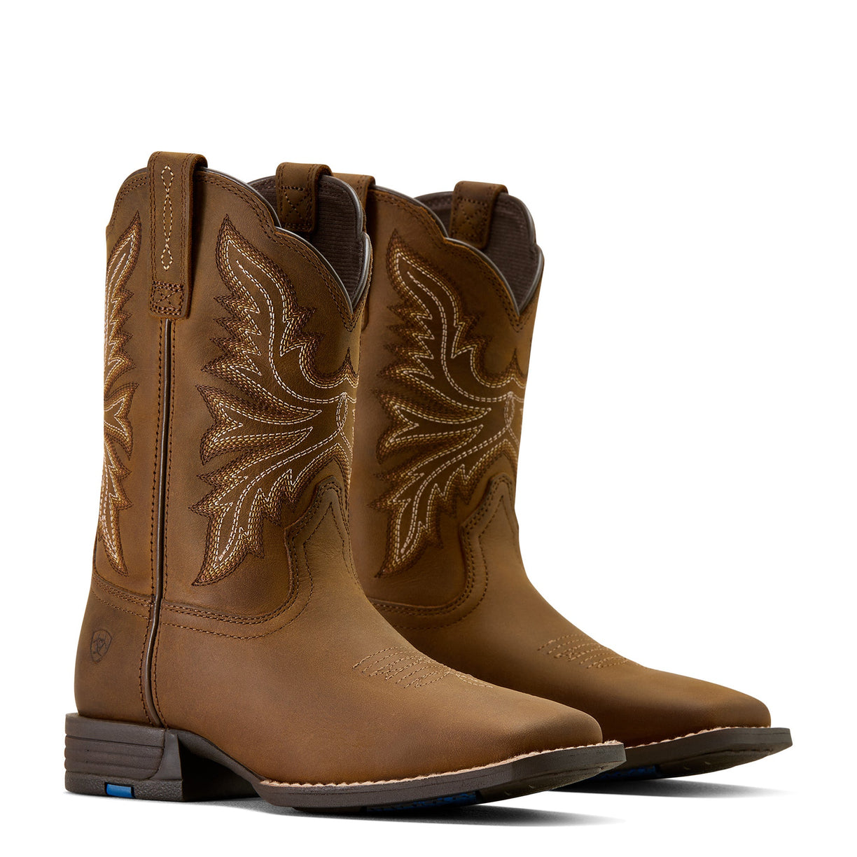 Pair of brown cowboy boots with intricate designs on a white background
