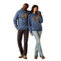Two people wearing matching blue hoodies with a logo on a white background