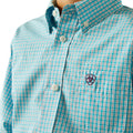 Close-up of a turquoise and white checkered shirt with a brand logo on a white background