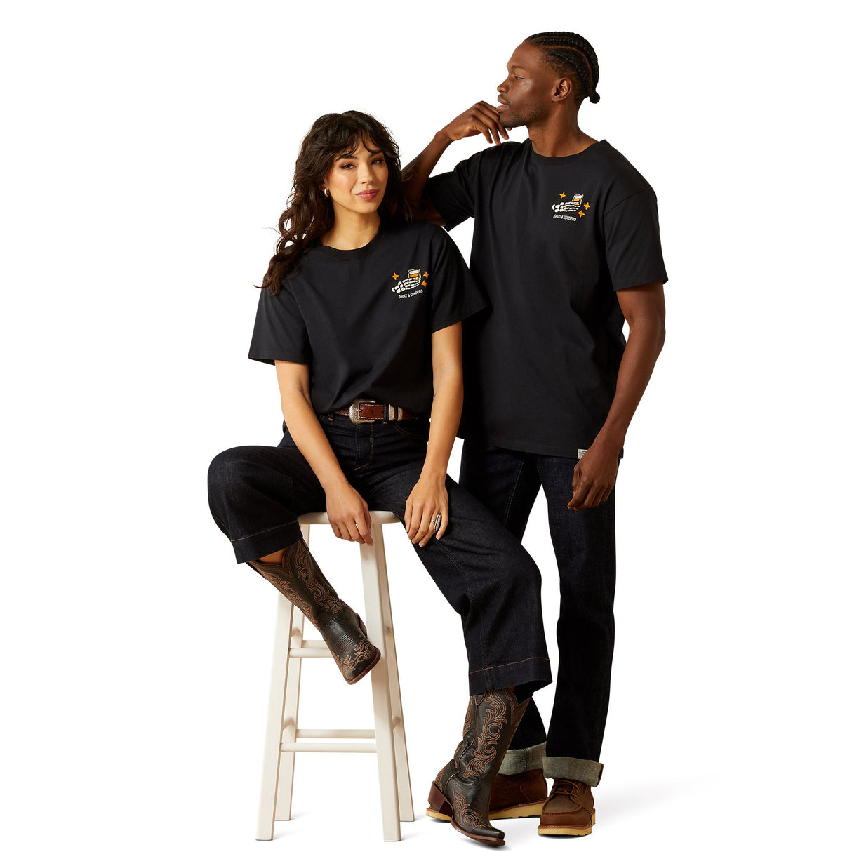 Two people wearing black t-shirts with logos on a white background