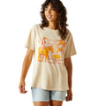Woman wearing a beige t-shirt with a graphic design on a white background