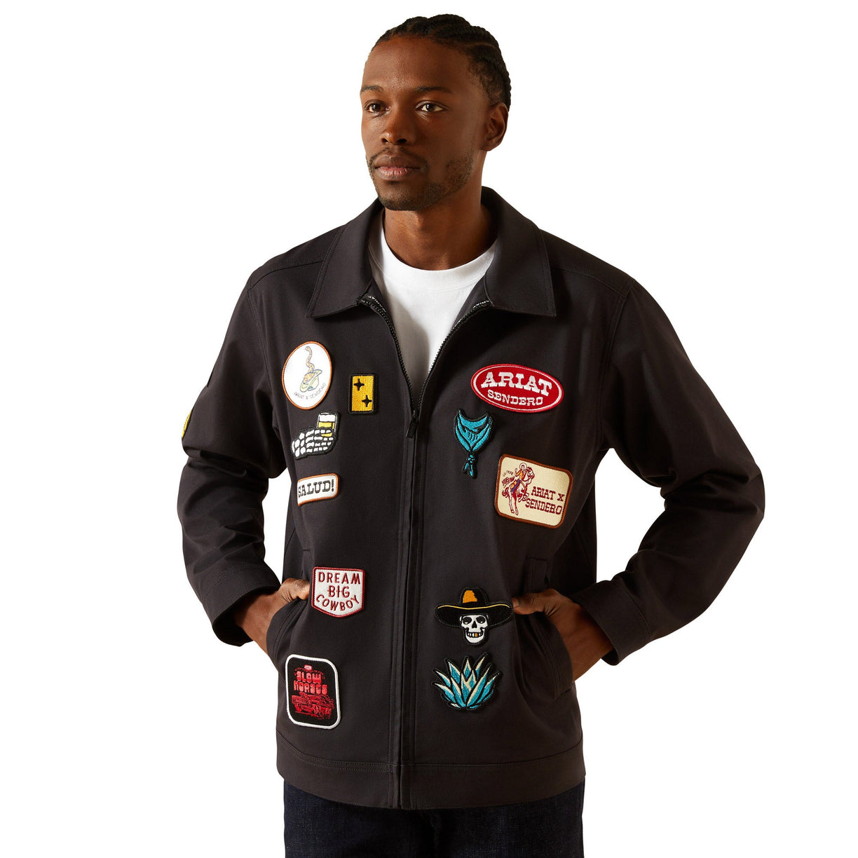Man wearing a black jacket with various patches on a white background