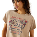 Woman wearing a beige t-shirt with 'Wild West Country Fest' graphic design.
