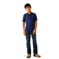 Young boy wearing a blue polo shirt and jeans on a white background