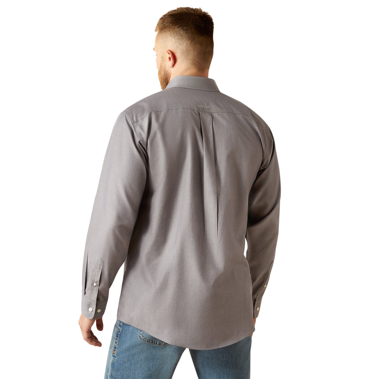 Man wearing a gray shirt and blue jeans on a white background