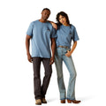 Two people wearing matching blue t-shirts and jeans on a white background