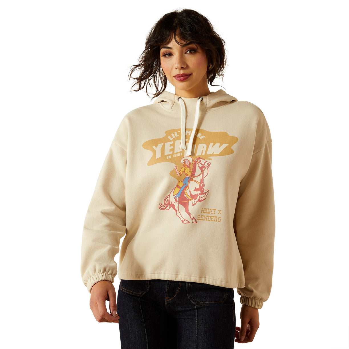 Woman wearing a beige hoodie with graphic design on a white background