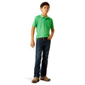 Child wearing a green polo shirt and blue jeans on a white background