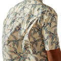 Beige shirt with tropical leaf pattern worn by a person