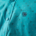 Close-up of a turquoise shirt with bull head pattern and embroidered logo.