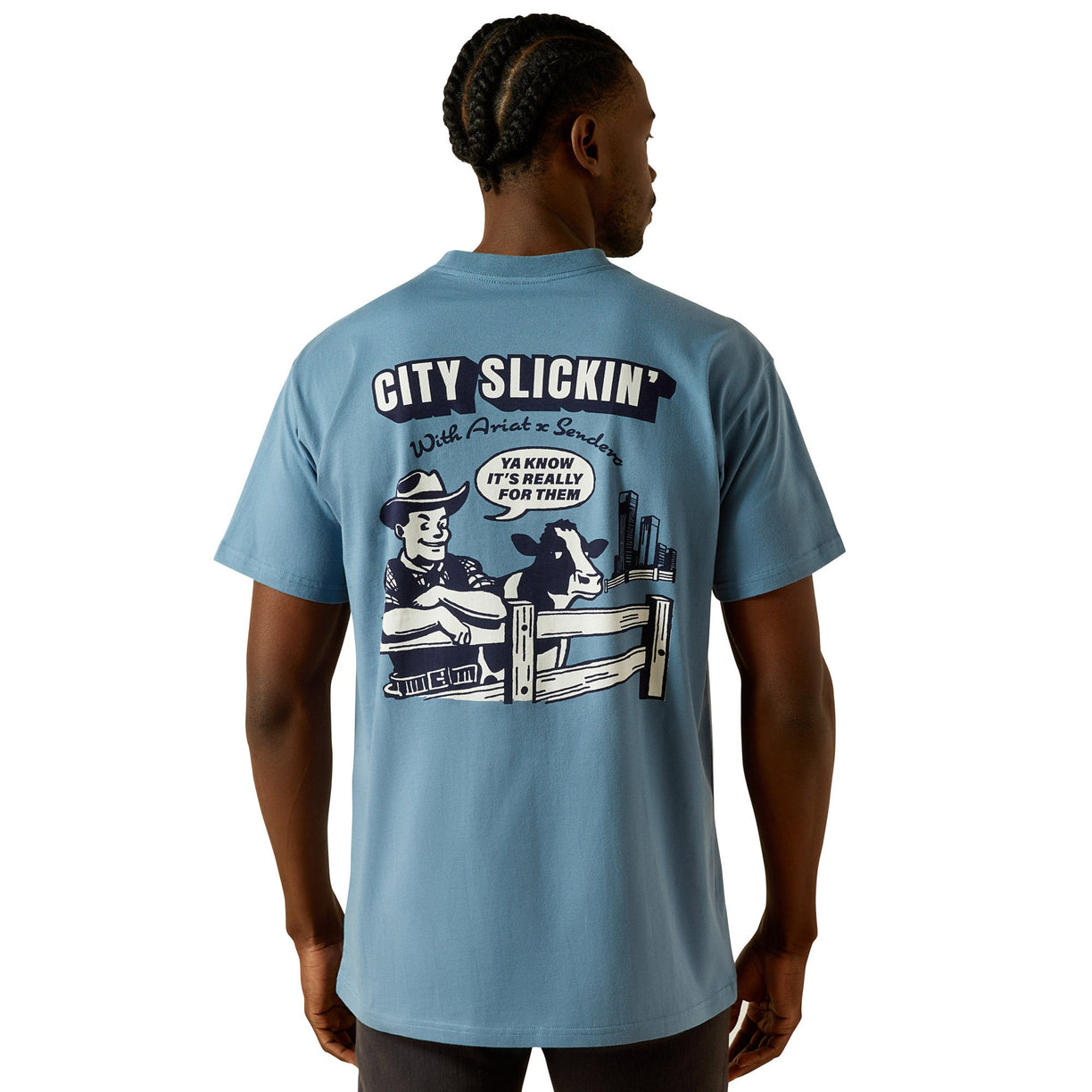 Light blue t-shirt with graphic design and text on the back, worn by a person.
