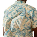 Beige shirt with blue tropical leaf pattern worn by a person