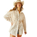 Woman wearing a beige patterned shirt and cowboy hat on a white background