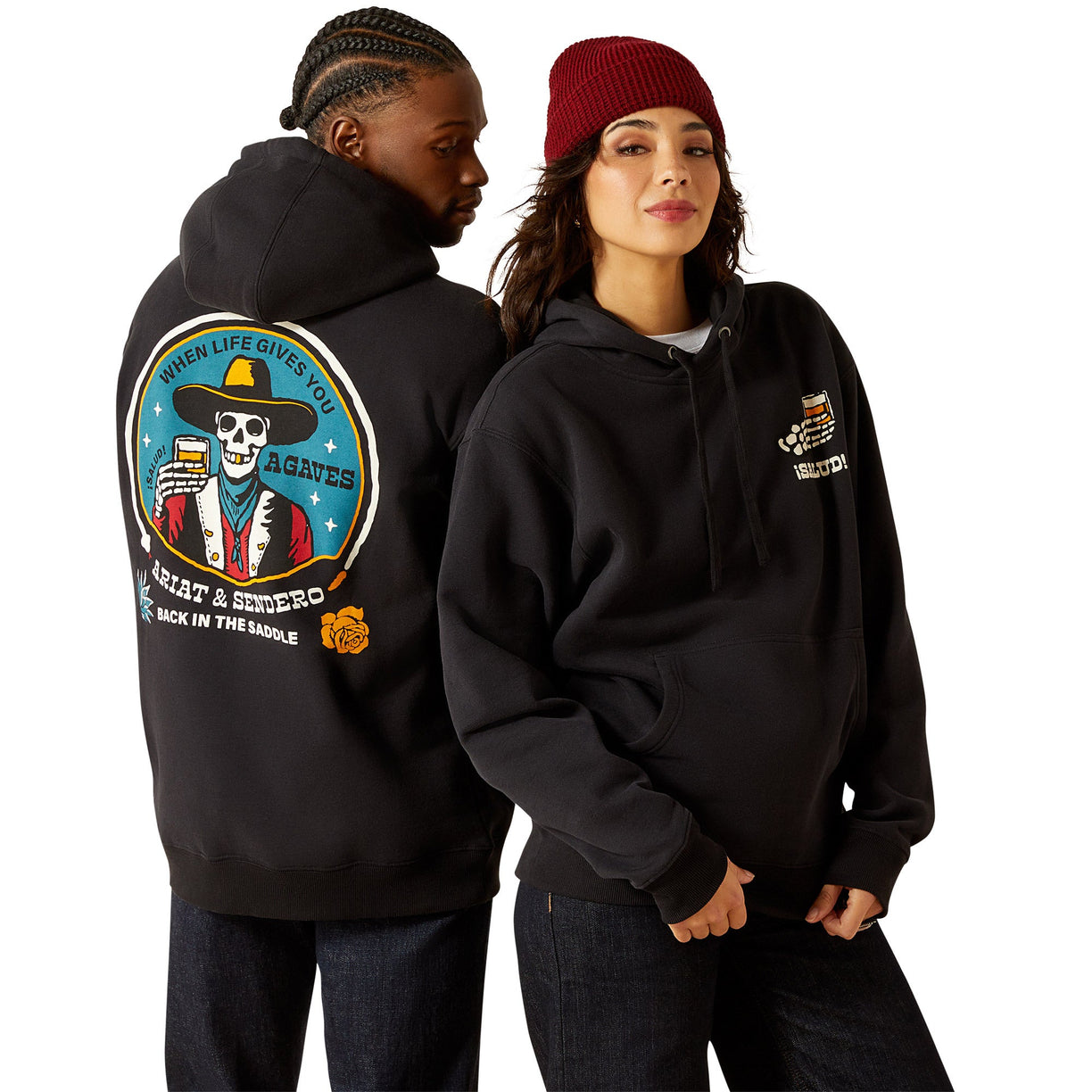 Two people wearing black hoodies with visible designs on a white background