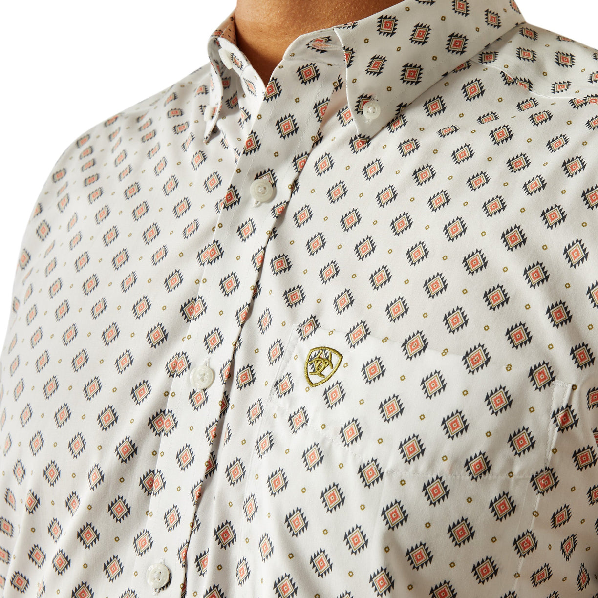 Close-up of a patterned shirt with a visible brand logo.