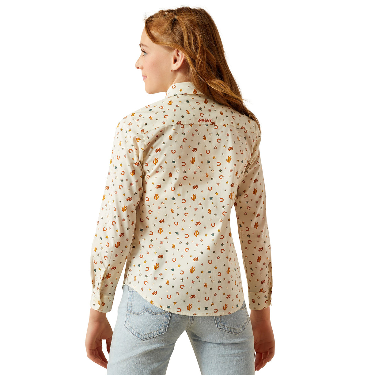 Woman wearing a patterned shirt with a visible brand logo on a white background