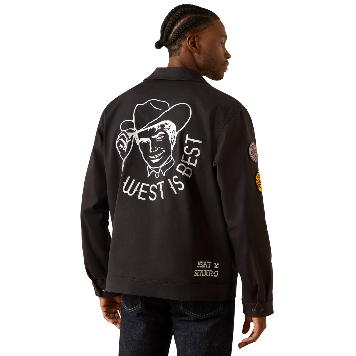 Person wearing a black jacket with a graphic design on the back, featuring text and a face.