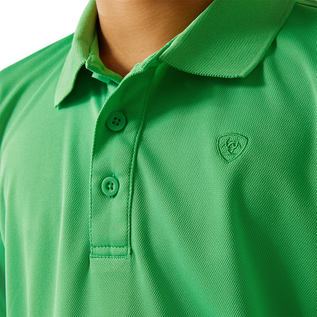 Close-up of a green polo shirt with a logo on a white background