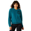 Woman wearing a teal sweatshirt with a graphic design on a white background
