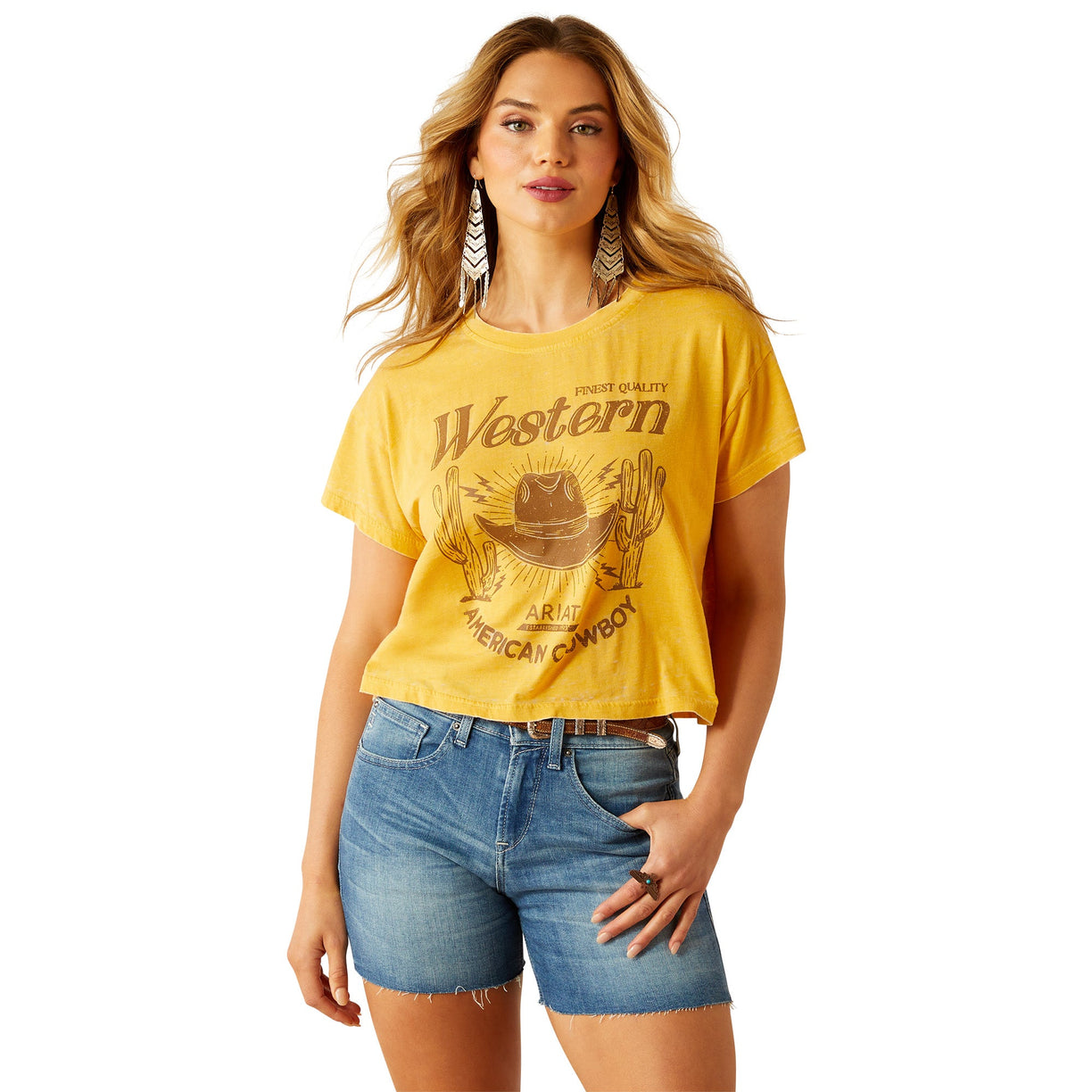 Woman wearing a yellow 'Western' t-shirt and denim shorts on a white background