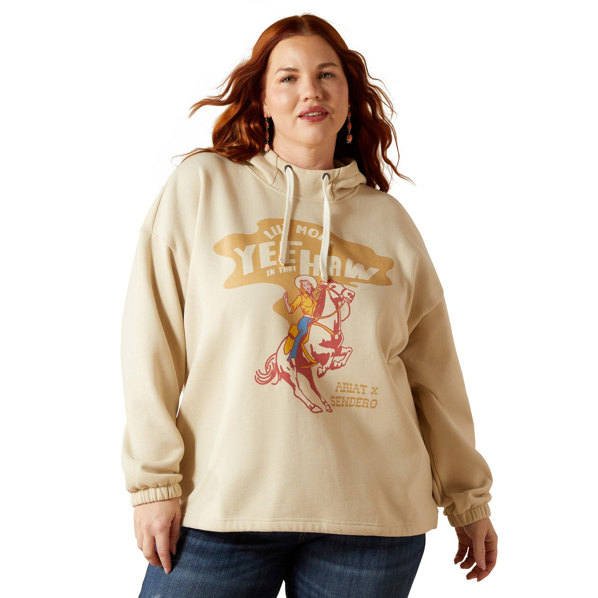 Woman wearing a beige hoodie with graphic design on a white background