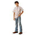 Young boy wearing a patterned shirt and jeans on a white background