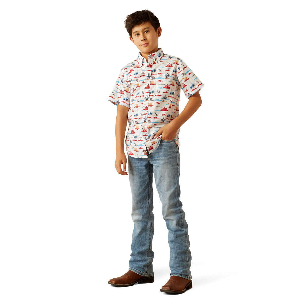 Young boy wearing a patterned shirt and jeans on a white background