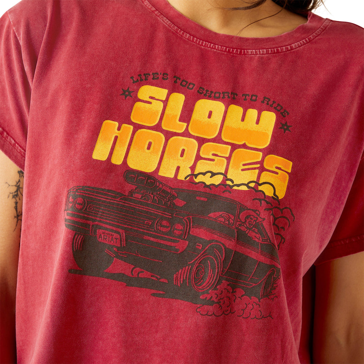 Red t-shirt with 'Slow Horses' graphic design on a person wearing it.