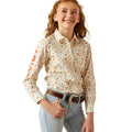 Young girl wearing a patterned shirt and jeans on a white background