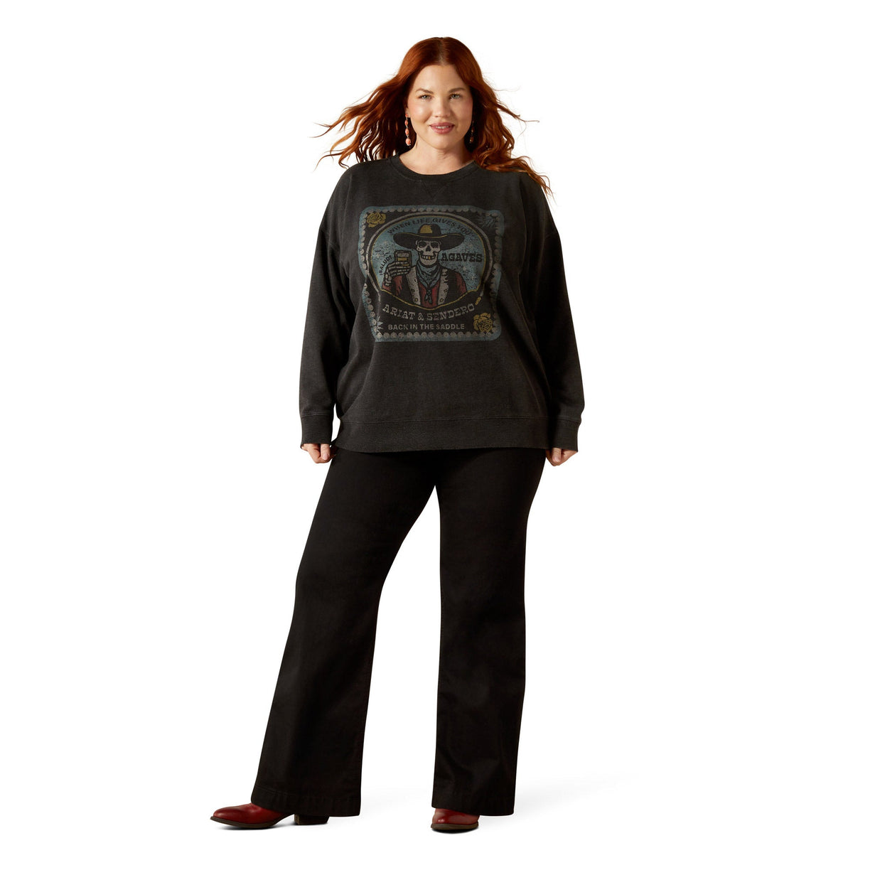 Woman wearing a dark gray sweatshirt with a graphic design on a white background