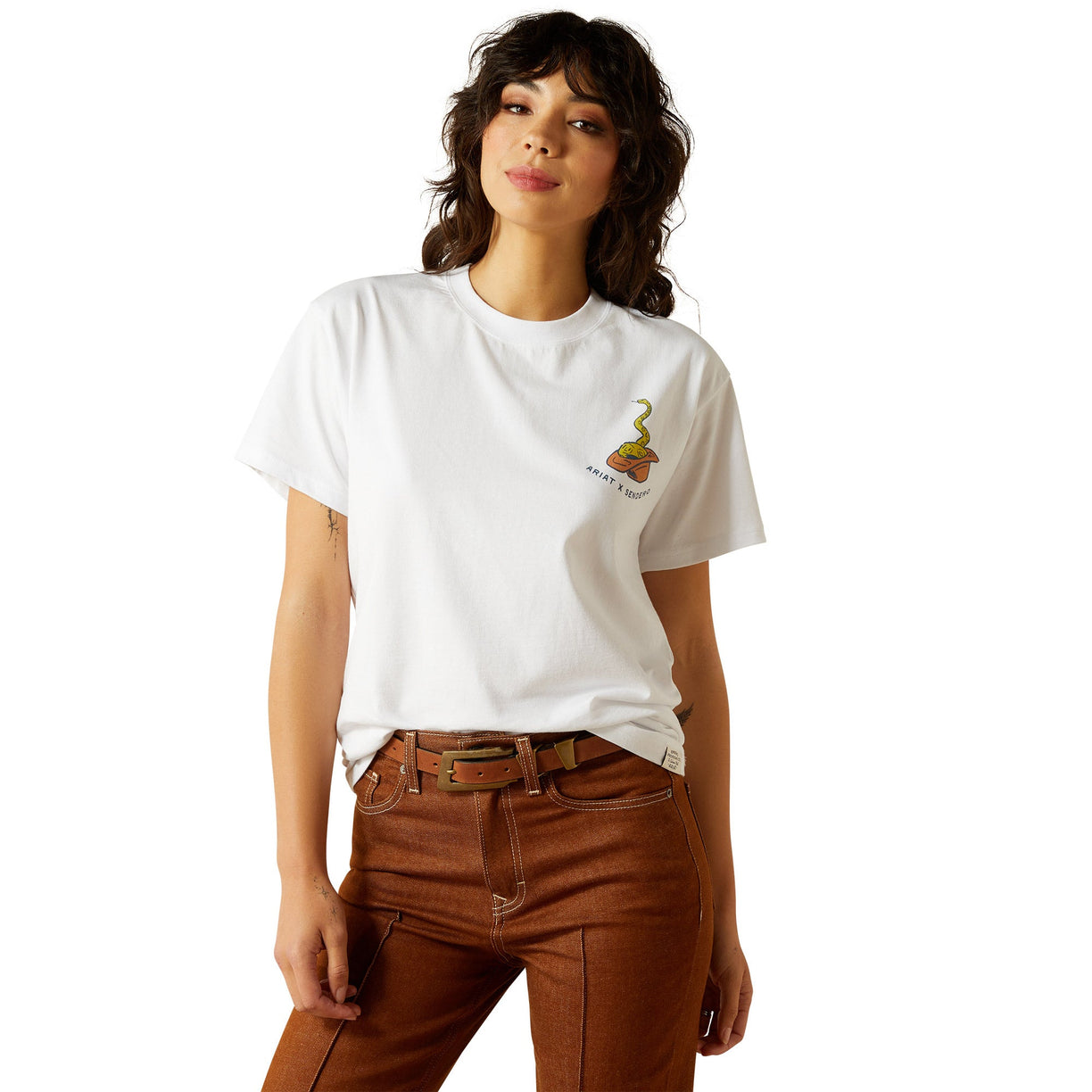Person wearing a white t-shirt with a logo and brown pants on a white background