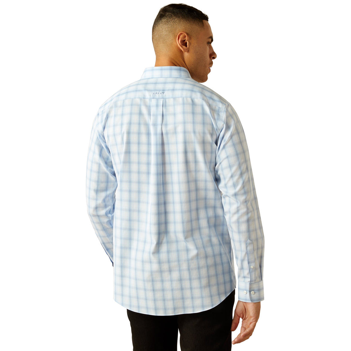 Man wearing a light blue checkered shirt on a white background
