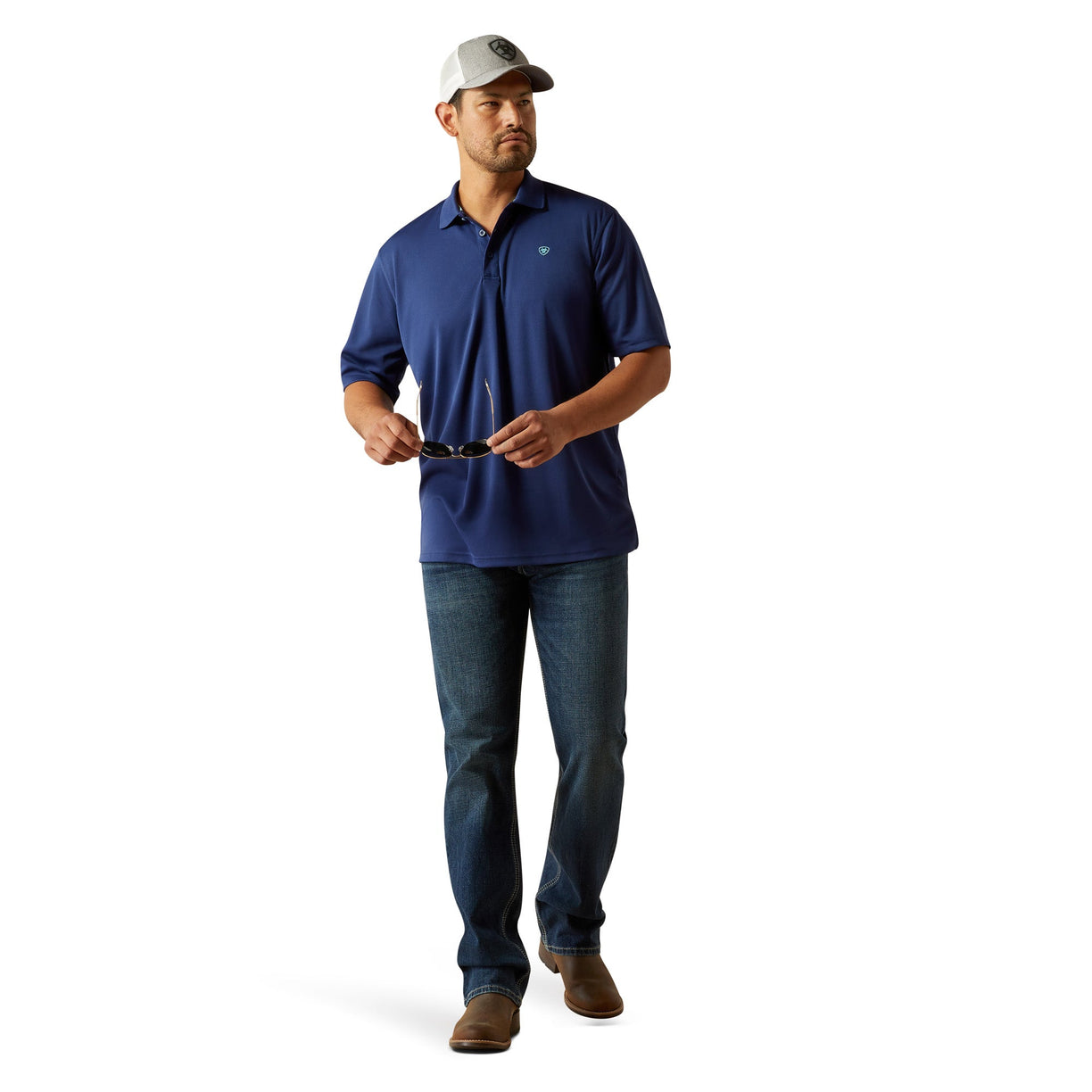 Man wearing a blue polo shirt and jeans on a white background