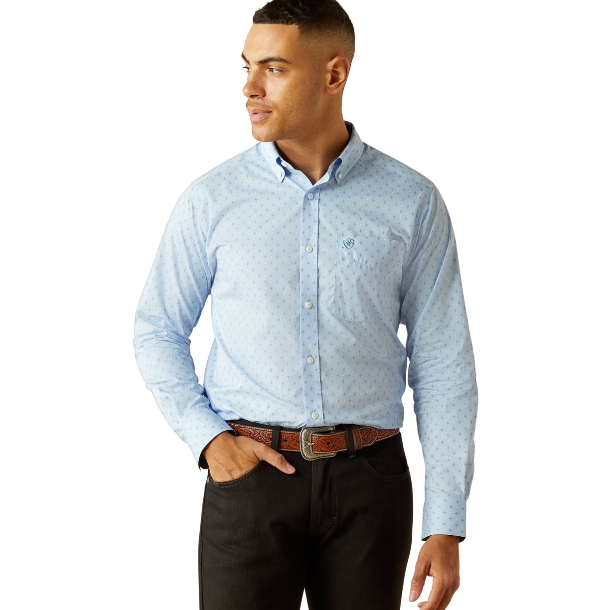 Man wearing a light blue patterned shirt and black pants on a white background