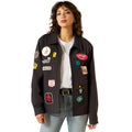 Woman wearing a black jacket with various patches on a white background