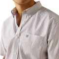 Close-up of a striped shirt with a visible brand logo on a white background