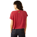 Person wearing a red t-shirt with a logo on the back, standing against a white background