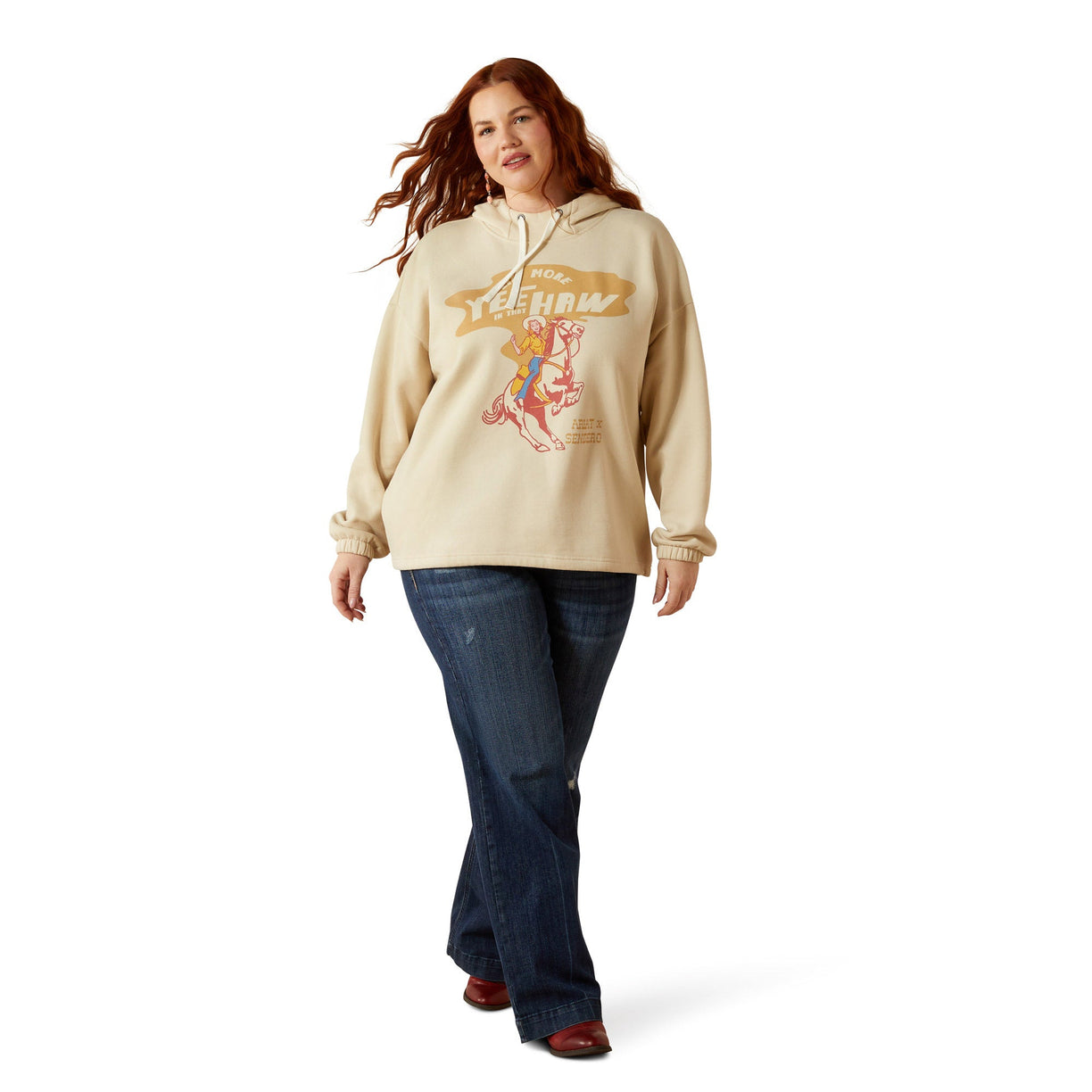 Woman wearing a beige hoodie with graphic design on a white background
