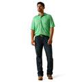 Man wearing a green polo shirt and blue jeans on a white background
