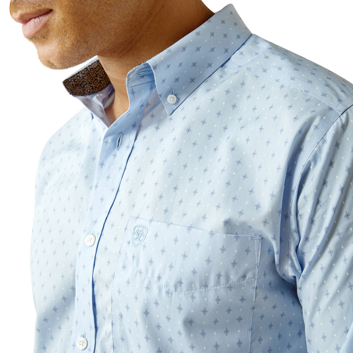 Light blue patterned shirt worn by a person on a white background